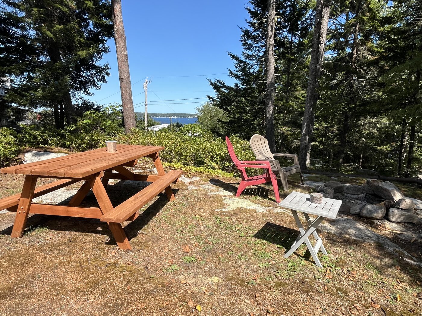 Picnic table and seating area with a water view near Outer Heron Cottage
